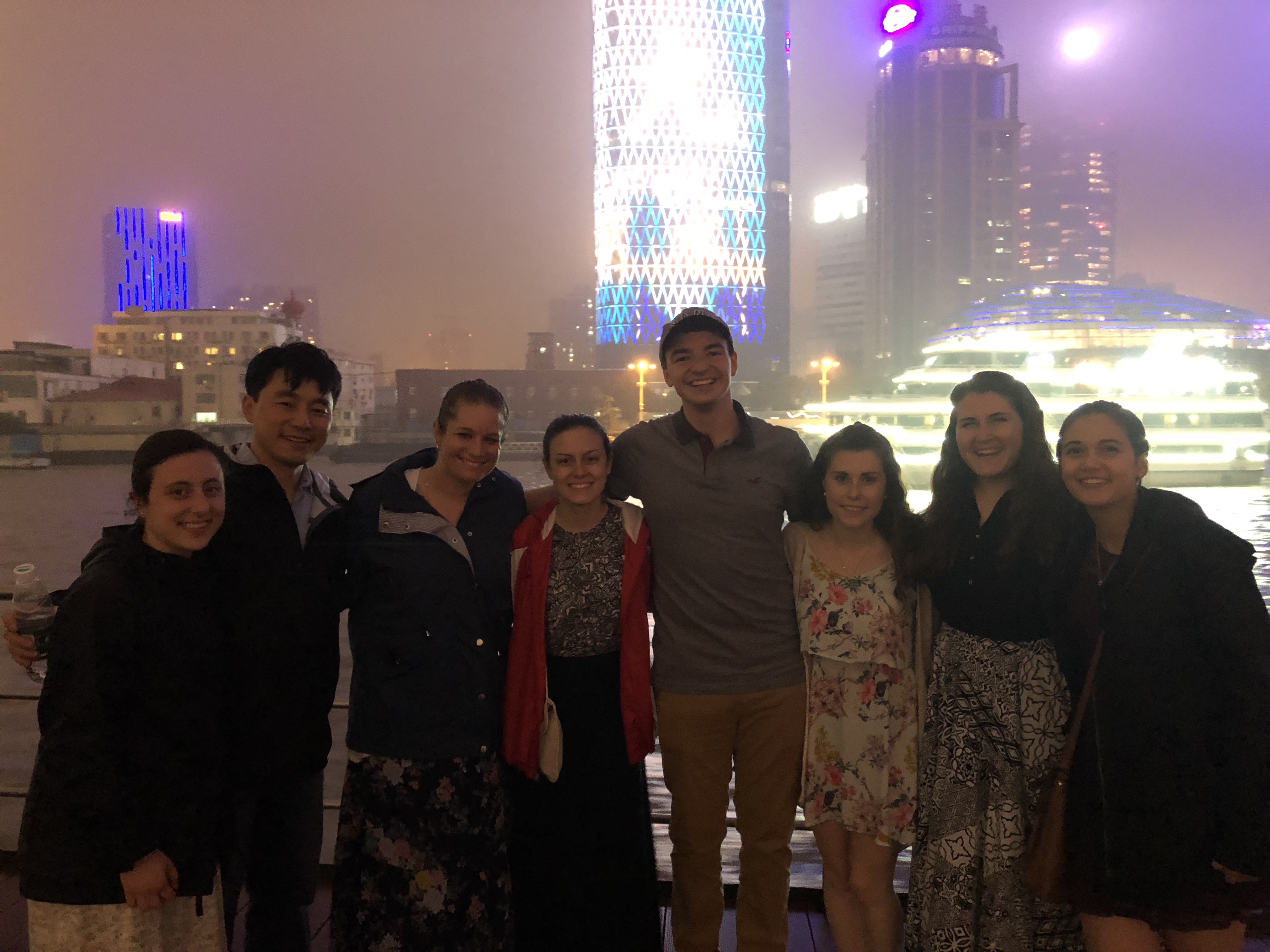 Student group in front of buildings at night